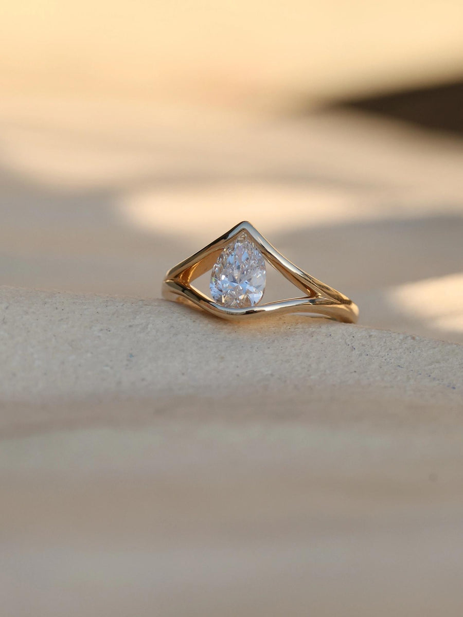 Pear cut lab grown diamond split shank engagement ring, 1.0 to 3.0 carats, set in elegant prong design on polished gold band