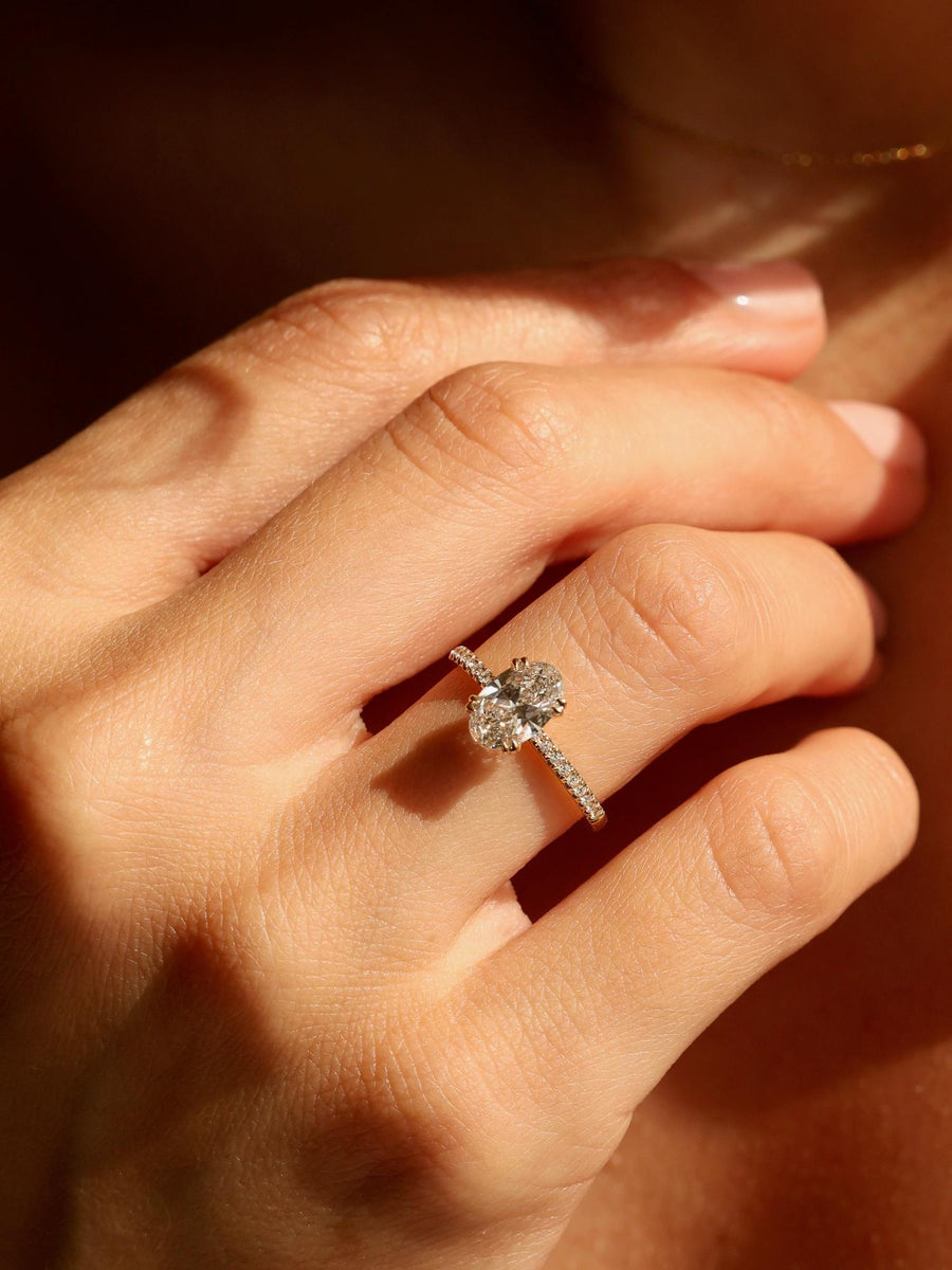 Oval cut lab grown diamond pavé engagement ring, 1.20 to 3.20 carats, with side stones set in a polished gold band