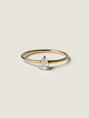 0.20 carat pear cut lab grown diamond solitaire engagement ring in prong setting with polished gold band