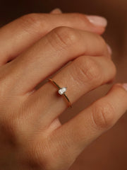 0.20 carat pear cut lab grown diamond solitaire engagement ring in prong setting with polished gold band