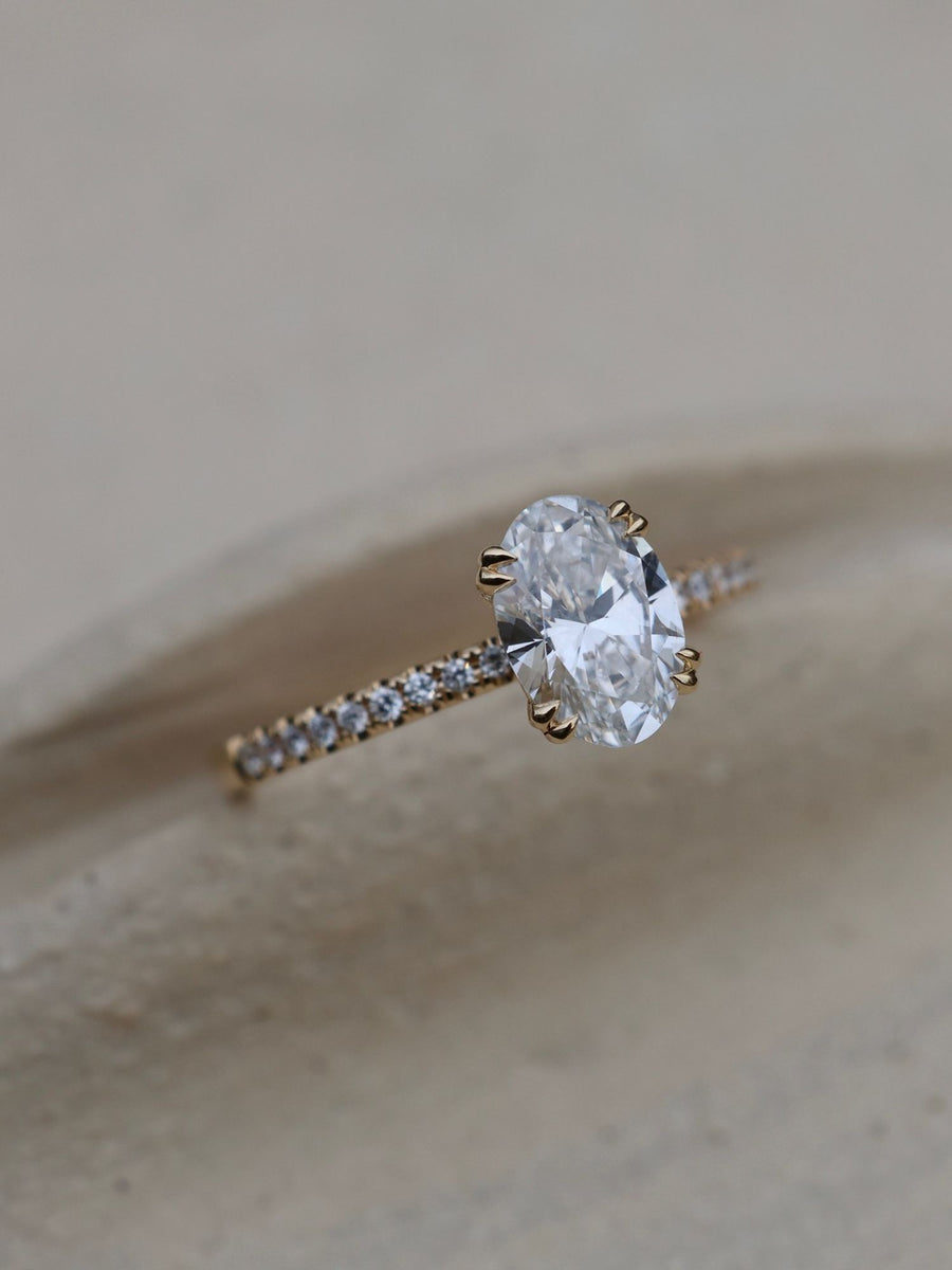 Oval cut lab grown diamond pavé engagement ring, 1.20 to 3.20 carats, with side stones set in a polished gold band
