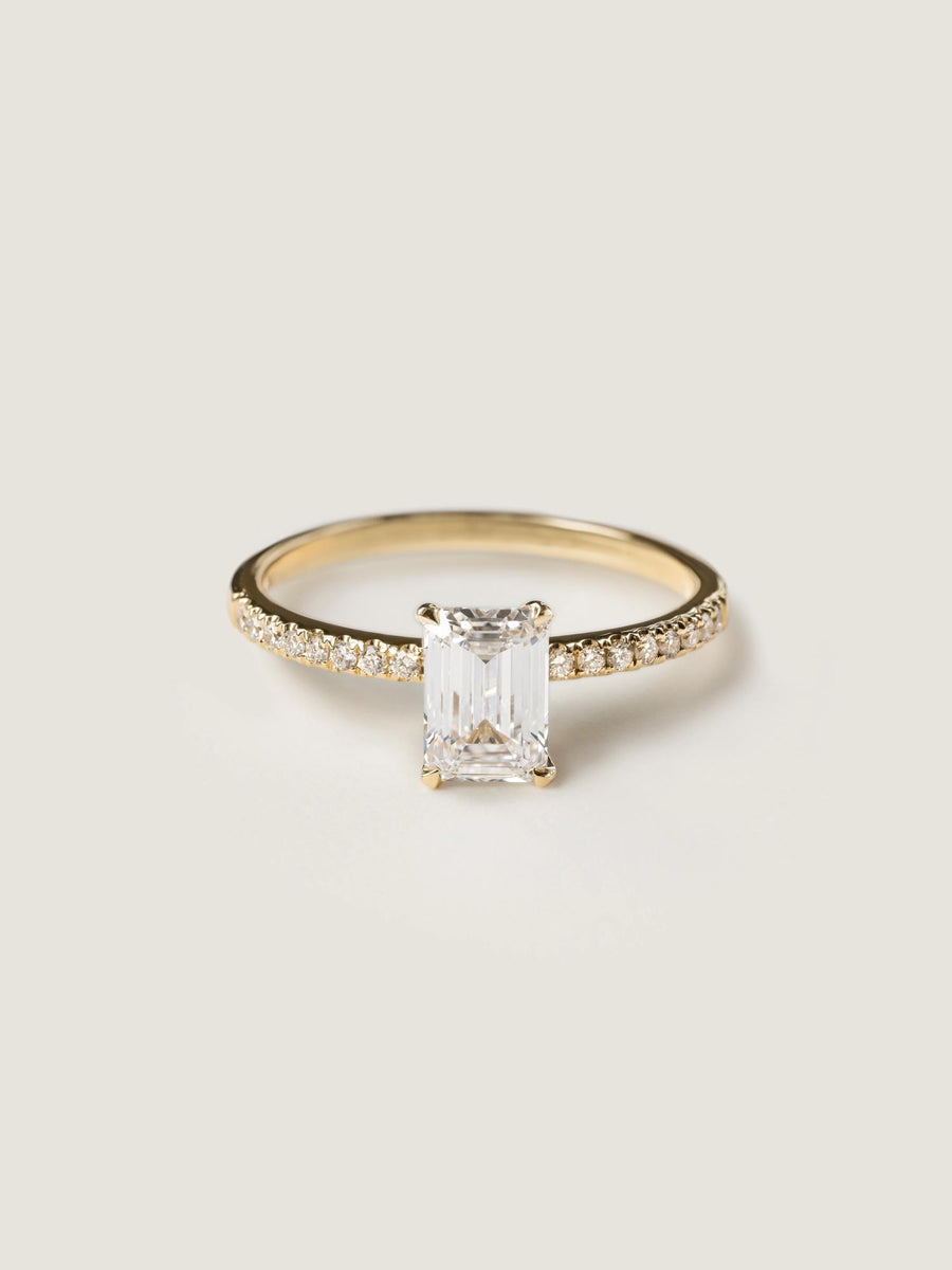 Emerald cut lab grown diamond pavé engagement ring, 0.90 to 2.50 carats, with side stones in a sleek prong setting on gold band