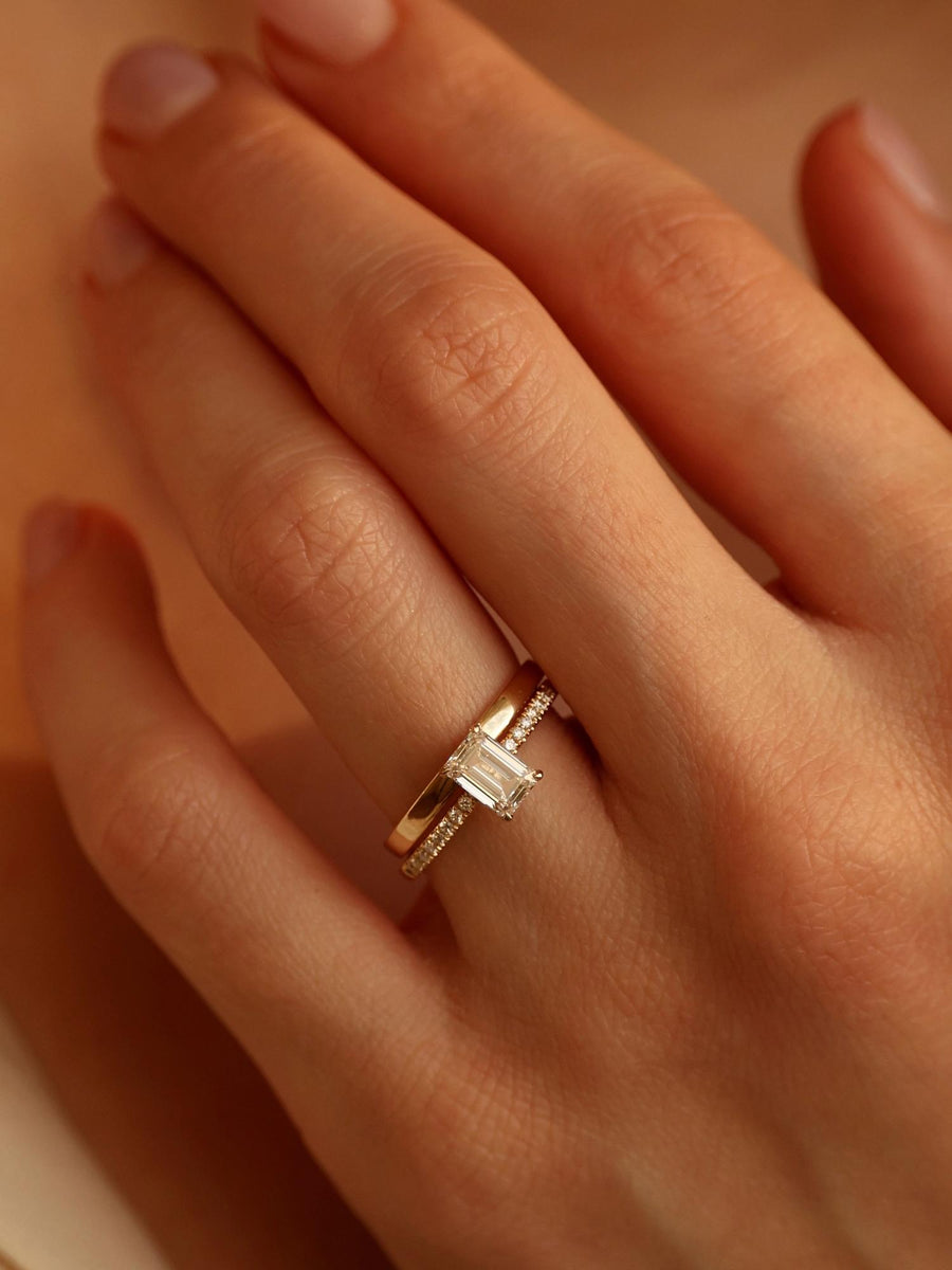 Emerald cut lab grown diamond pavé engagement ring, 0.90 to 2.50 carats, with side stones in a sleek prong setting on gold band
