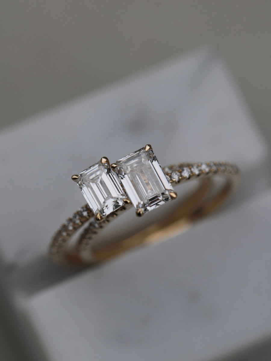 Emerald cut lab grown diamond pavé engagement ring, 0.90 to 2.50 carats, with side stones in a sleek prong setting on gold band