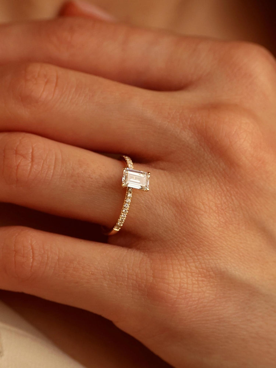 Emerald cut lab grown diamond pavé engagement ring, 0.90 to 2.50 carats, with side stones in a sleek prong setting on gold band