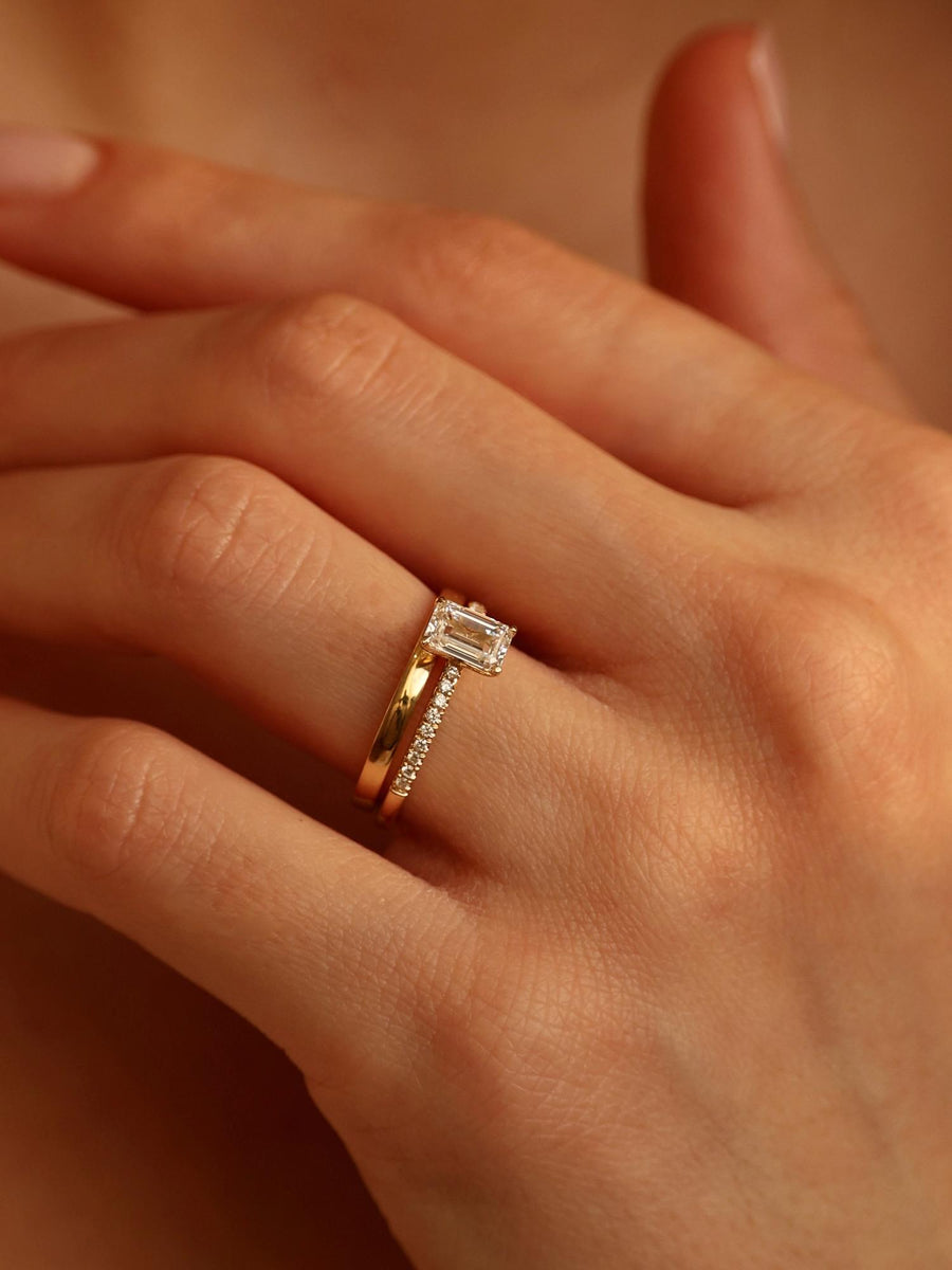 Emerald cut lab grown diamond pavé engagement ring, 0.90 to 2.50 carats, with side stones in a sleek prong setting on gold band