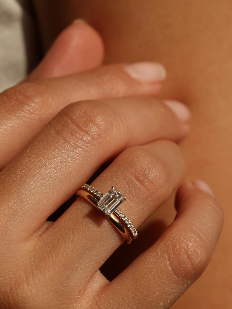 Emerald cut lab grown diamond pavé engagement ring, 0.90 to 2.50 carats, with side stones in a sleek prong setting on gold band