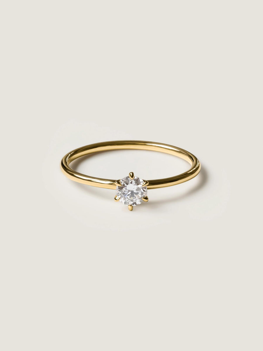 0.30 carat round cut lab grown diamond solitaire engagement ring in E/VS1 clarity, set in a sleek prong on gold band

