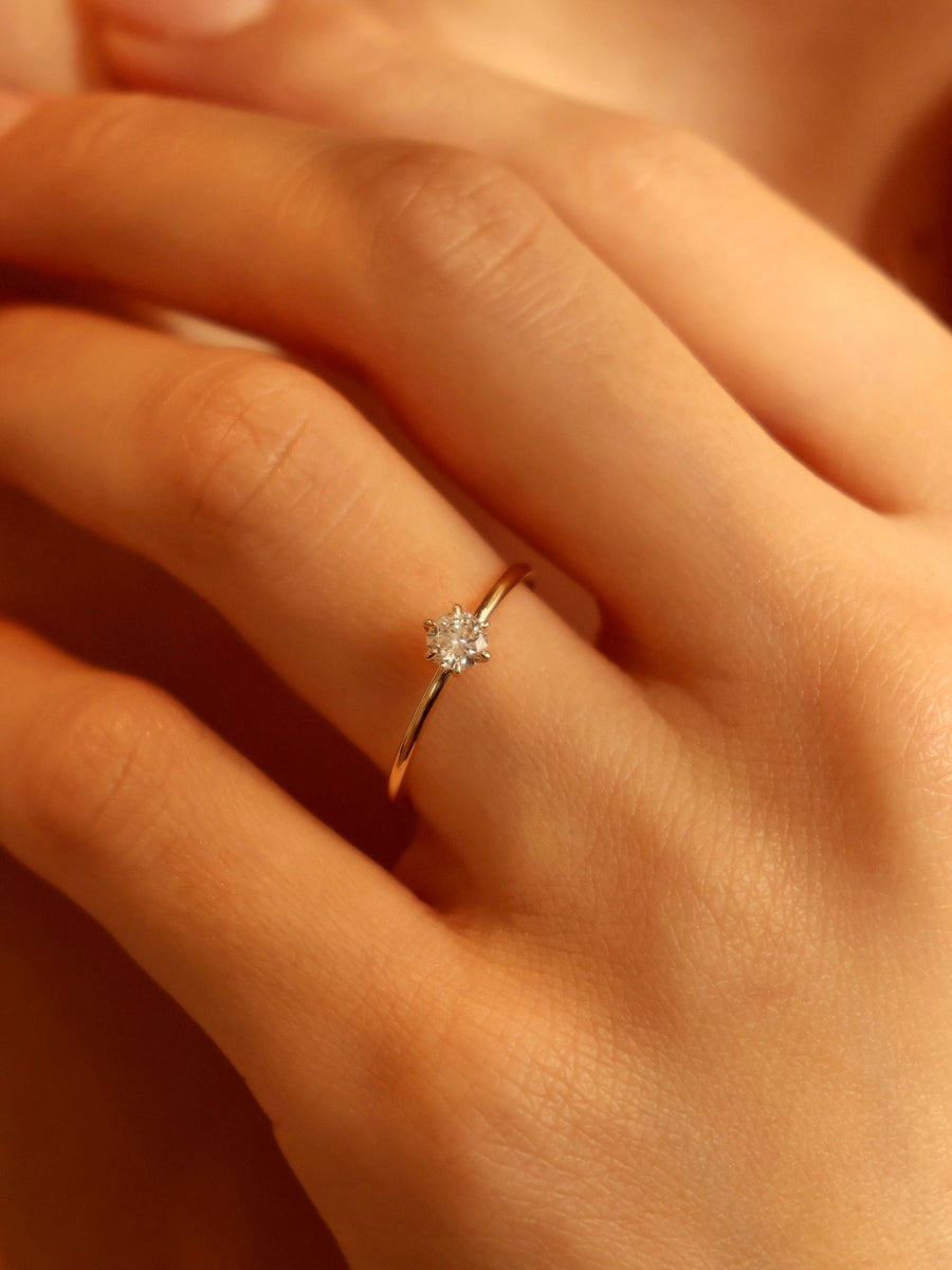 0.30 carat round cut lab grown diamond solitaire engagement ring in E/VS1 clarity, set in a sleek prong on gold band


