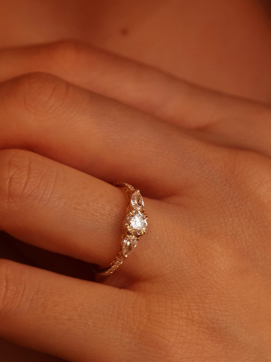 Round cut lab grown diamond three stone engagement ring, 0.50 to 2.50 carats, set in classic prong design on polished gold band