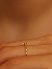 0.30 carat round cut lab grown diamond solitaire engagement ring in E/VS1 clarity, set in a sleek prong on gold band

