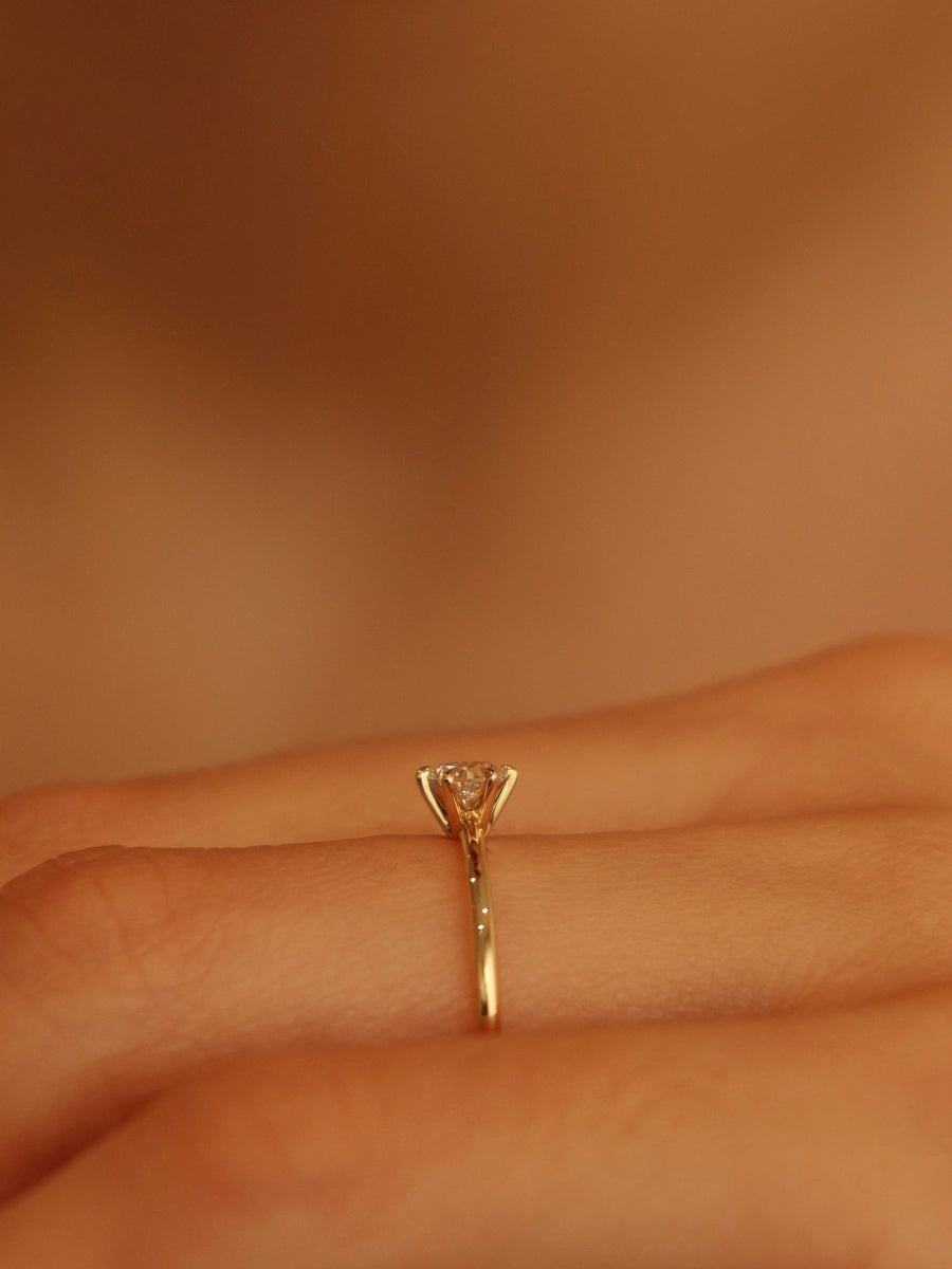 0.30 carat round cut lab grown diamond solitaire engagement ring in E/VS1 clarity, set in a sleek prong on gold band

