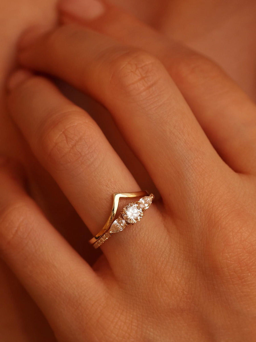 Round cut lab grown diamond three stone engagement ring, 0.50 to 2.50 carats, set in classic prong design on polished gold band