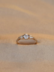 Round cut lab grown diamond three stone engagement ring, 0.50 to 2.50 carats, set in classic prong design on polished gold band