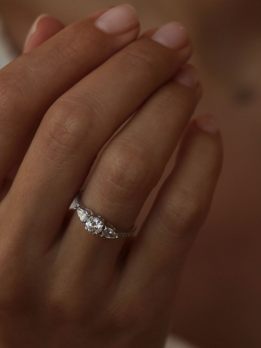 Round cut lab grown diamond three stone engagement ring, 0.50 to 2.50 carats, set in classic prong design on polished gold band