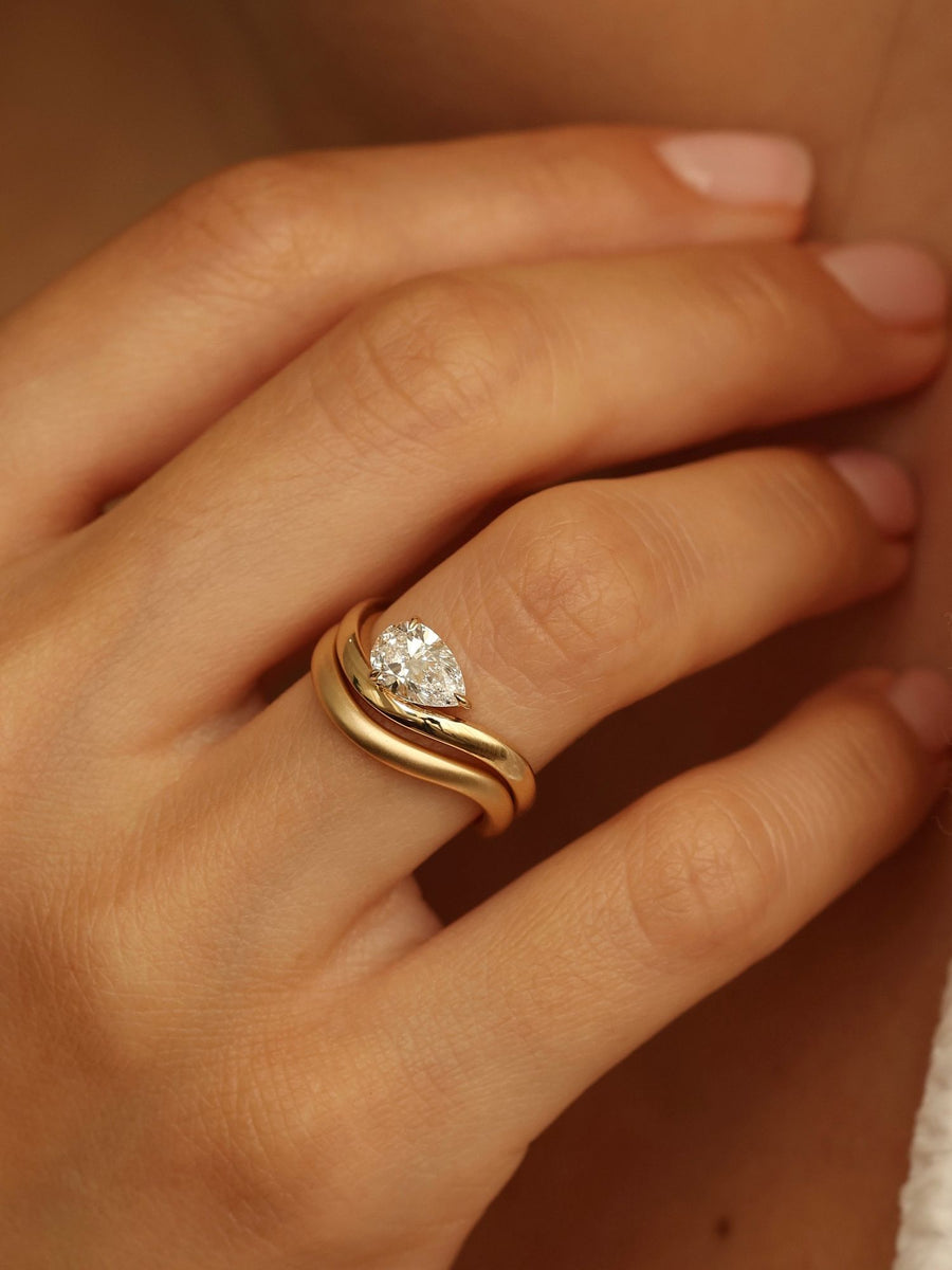 Pear cut lab grown diamond engagement ring, 1.0 to 3.0 carats, in a unique designer-inspired setting on polished gold band