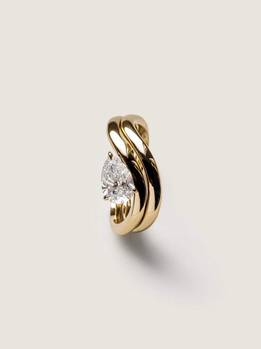 Pear cut lab grown diamond engagement ring, 1.0 to 3.0 carats, in a unique designer-inspired setting on polished gold band