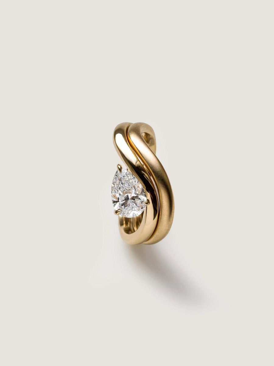 Pear cut lab grown diamond engagement ring, 1.0 to 3.0 carats, in a unique designer-inspired setting on polished gold band