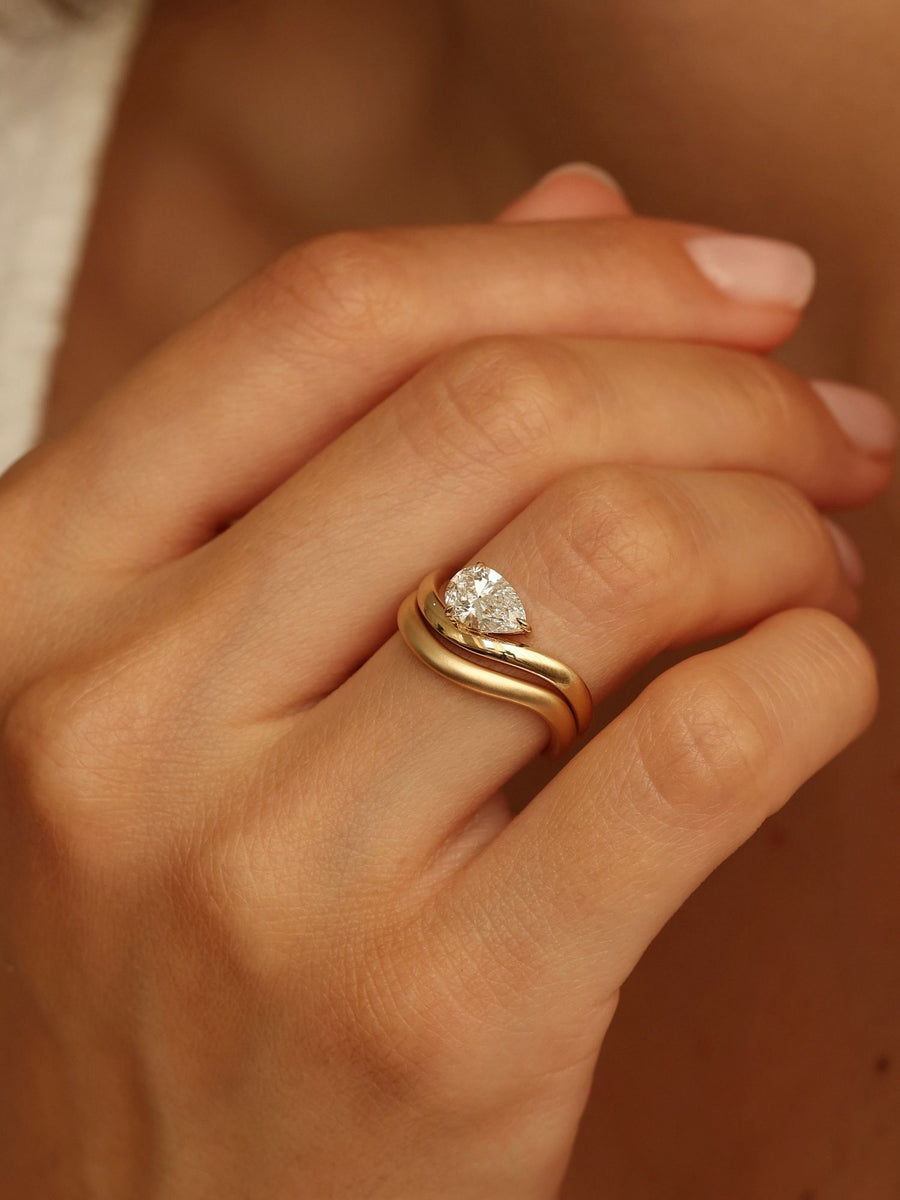 Pear cut lab grown diamond engagement ring, 1.0 to 3.0 carats, in a unique designer-inspired setting on polished gold band