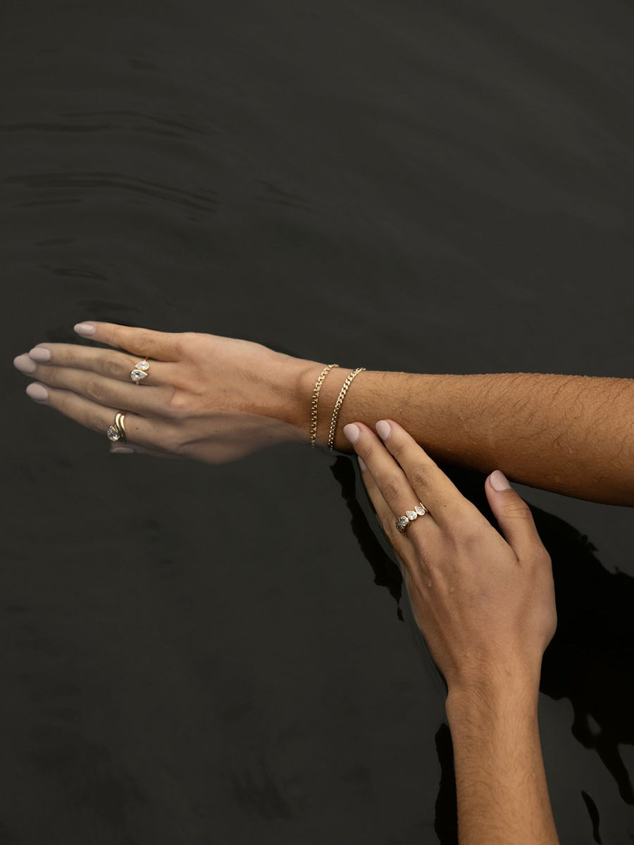 Pear cut lab grown diamond engagement ring, 1.0 to 3.0 carats, in a unique designer-inspired setting on polished gold band