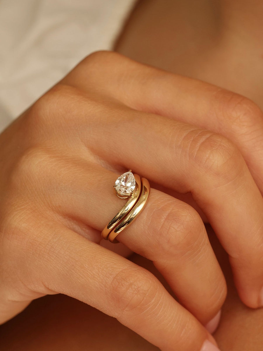 Pear cut lab grown diamond engagement ring, 1.0 to 3.0 carats, in a unique designer-inspired setting on polished gold band