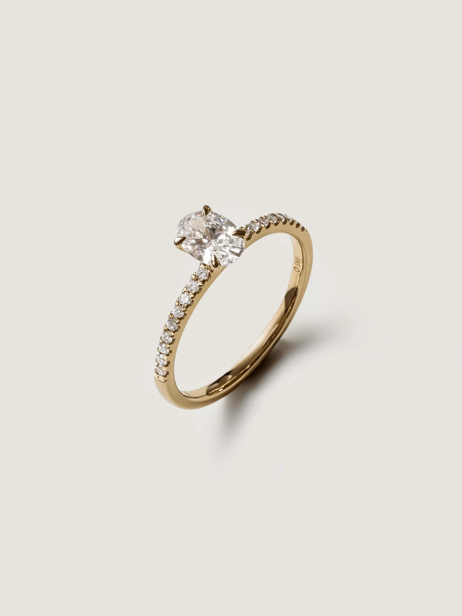 Oval cut lab grown diamond pavé engagement ring, 0.50 to 1.50 carats, with side stones in elegant prong setting on gold band