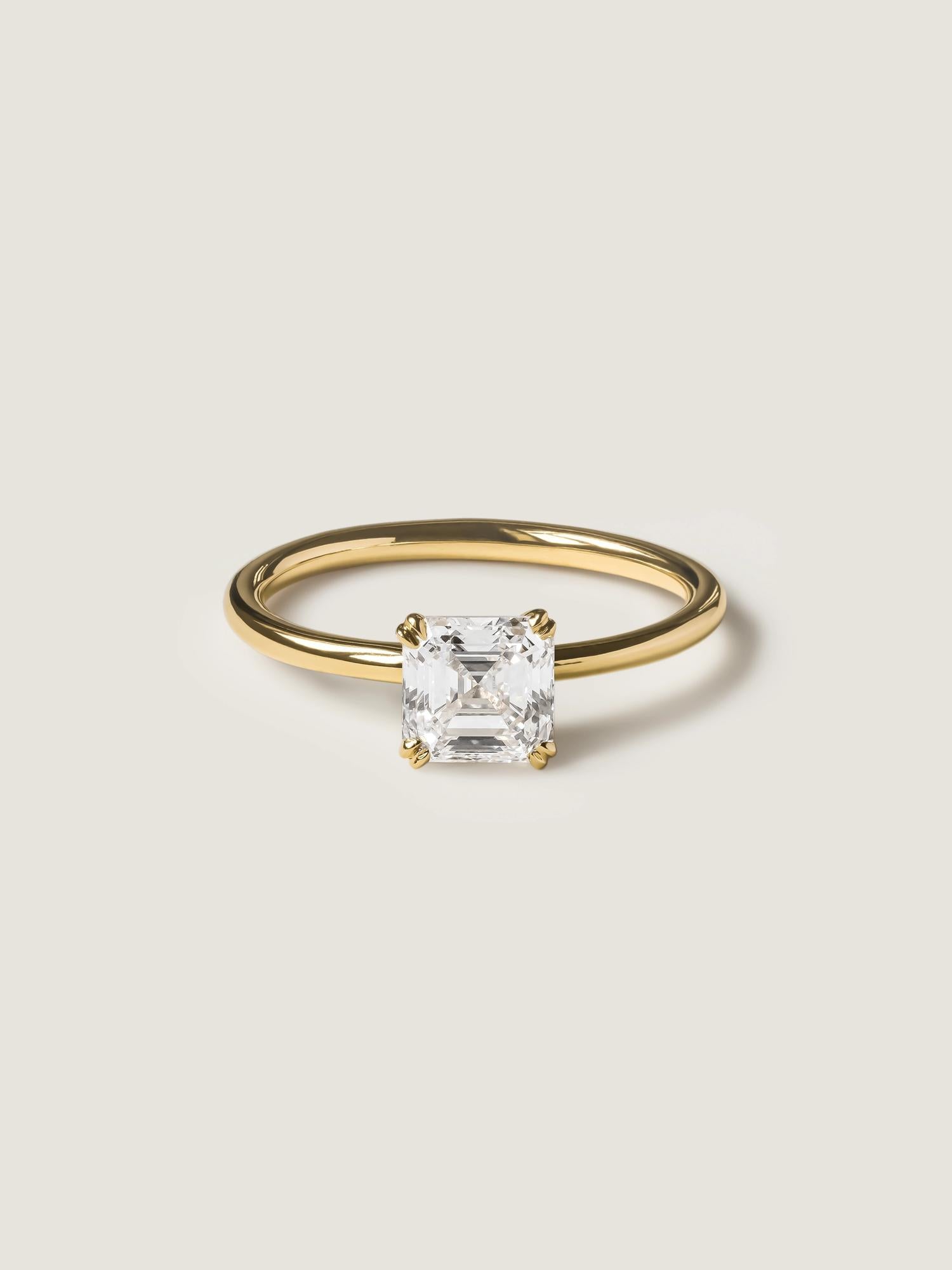 1.20 carat Asscher cut lab grown diamond solitaire engagement ring set in a classic prong design on polished gold band