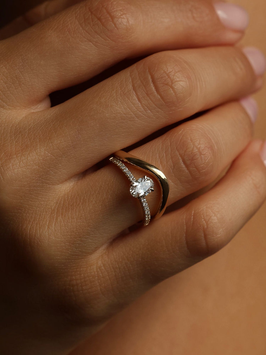 Oval cut lab grown diamond pavé engagement ring, 0.50 to 1.50 carats, with side stones in elegant prong setting on gold band