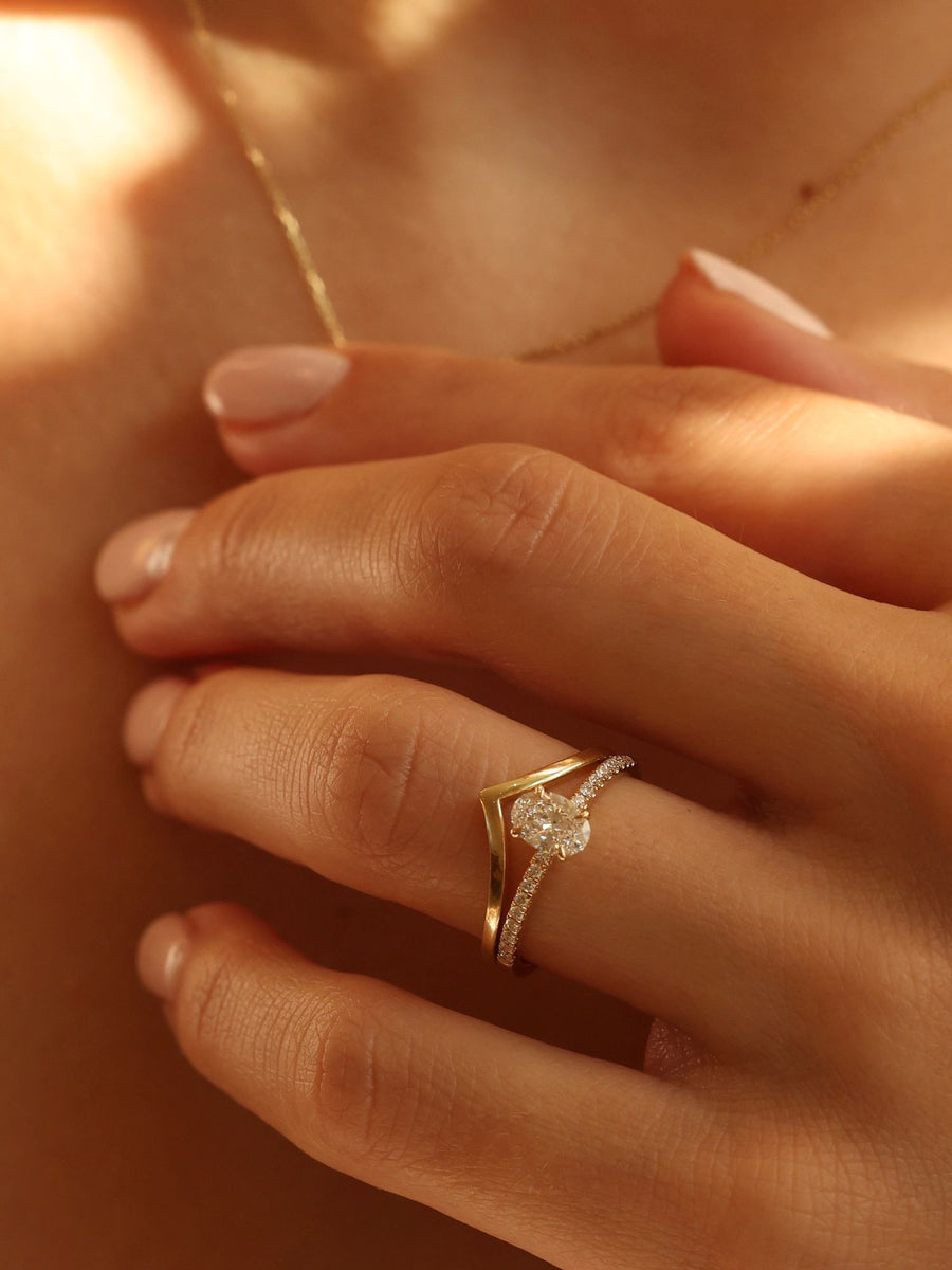 Oval cut lab grown diamond pavé engagement ring, 0.50 to 1.50 carats, with side stones in elegant prong setting on gold band