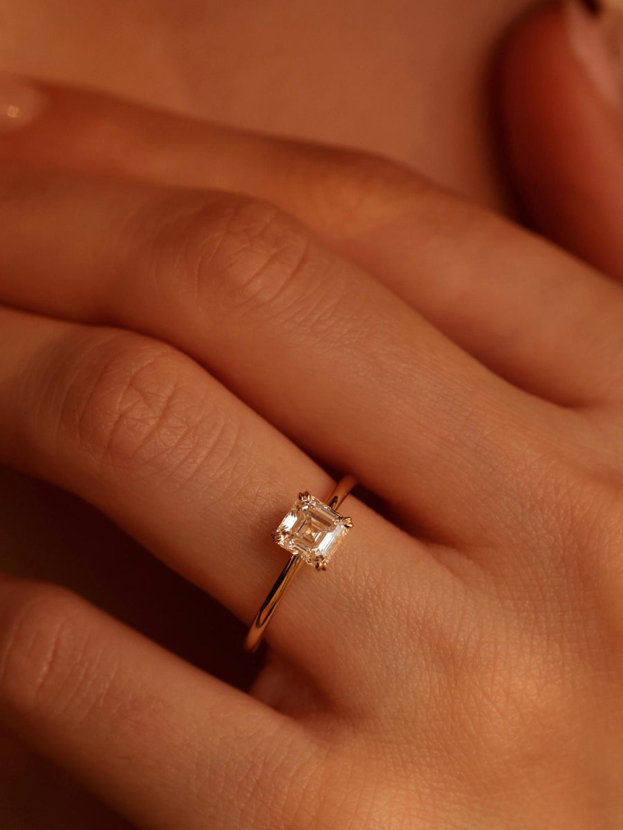 1.20 carat Asscher cut lab grown diamond solitaire engagement ring set in a classic prong design on polished gold band
