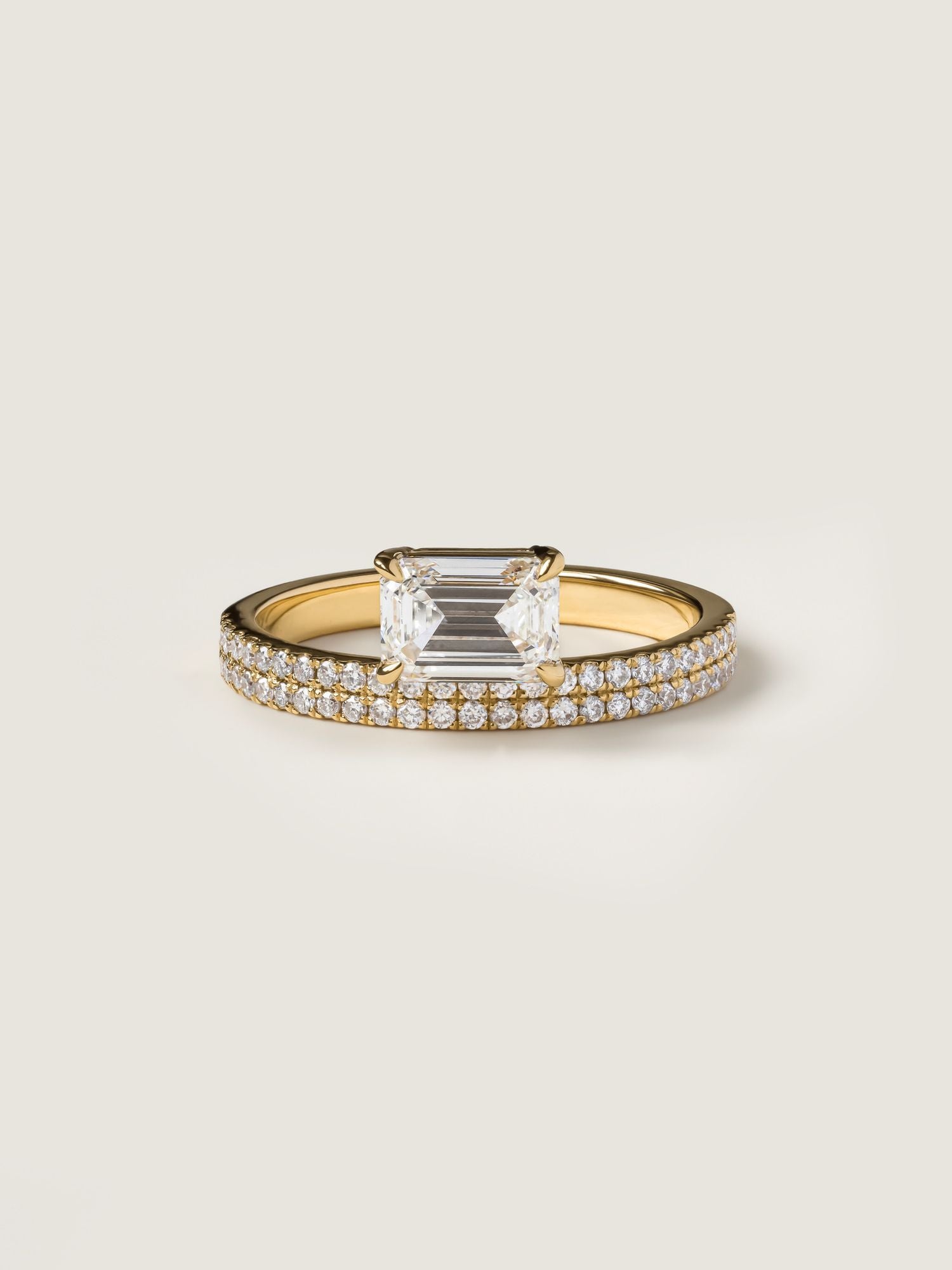 East-west emerald cut lab grown diamond pavé engagement ring, 1.0 to 3.0 carats, with side stones set in a polished gold band