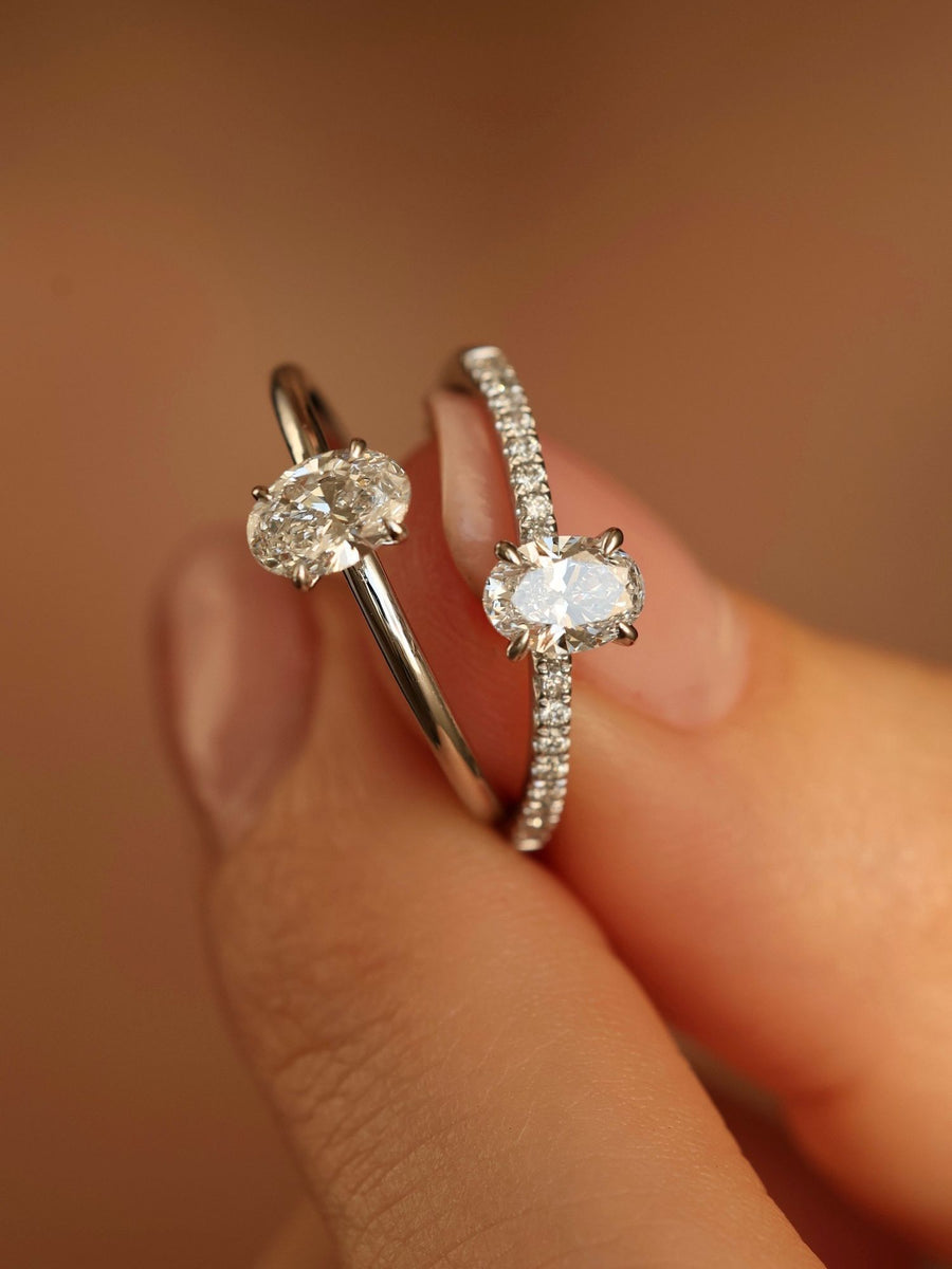 Oval cut lab grown diamond pavé engagement ring, 0.50 to 1.50 carats, with side stones in elegant prong setting on gold band