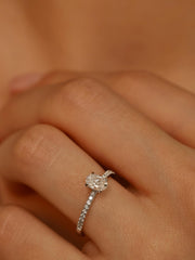 Oval cut lab grown diamond pavé engagement ring, 0.50 to 1.50 carats, with side stones in elegant prong setting on gold band