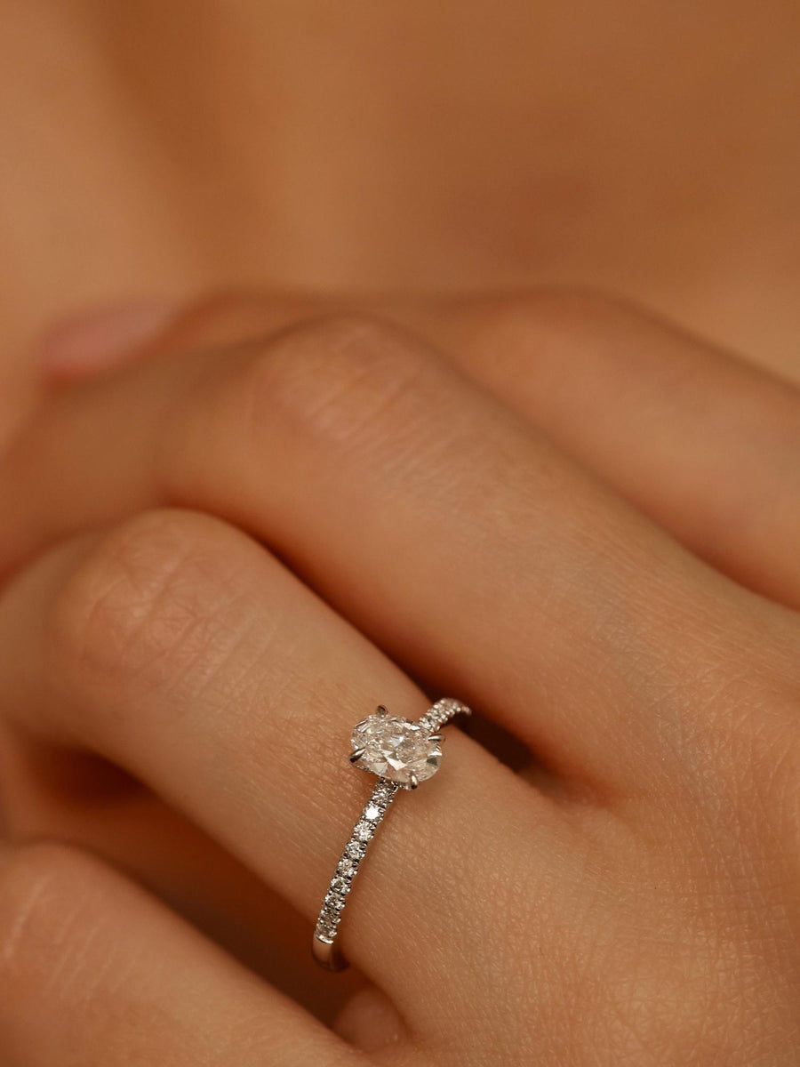 Oval cut lab grown diamond pavé engagement ring, 0.50 to 1.50 carats, with side stones in elegant prong setting on gold band