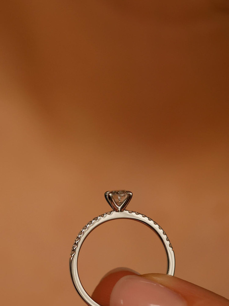 Oval cut lab grown diamond pavé engagement ring, 0.50 to 1.50 carats, with side stones in elegant prong setting on gold band