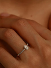 Oval cut lab grown diamond pavé engagement ring, 0.50 to 1.50 carats, with side stones in elegant prong setting on gold band