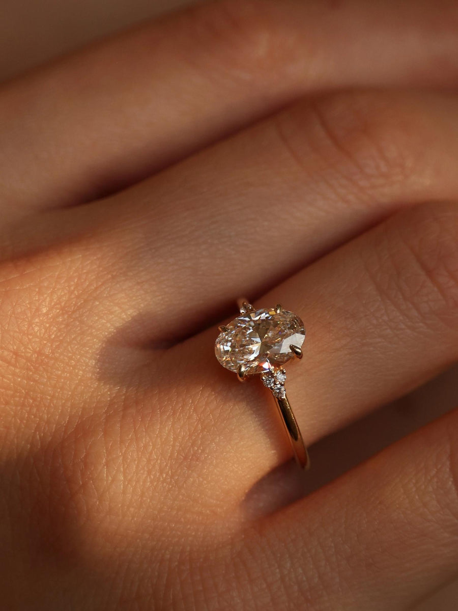 Oval cut lab grown diamond cluster engagement ring, 1.0 to 3.0 carats, featuring multiple accent stones set in a polished gold band