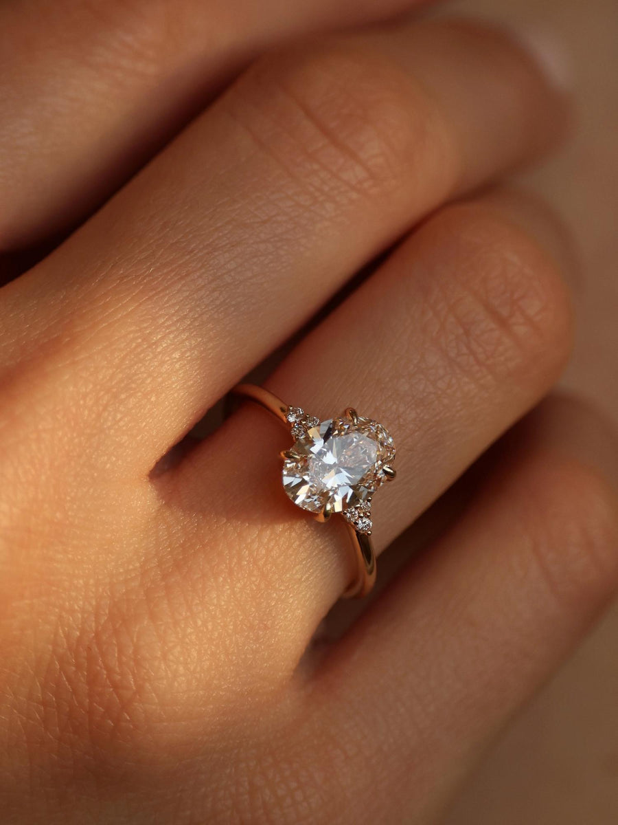 Oval cut lab grown diamond cluster engagement ring, 1.0 to 3.0 carats, featuring multiple accent stones set in a polished gold band
