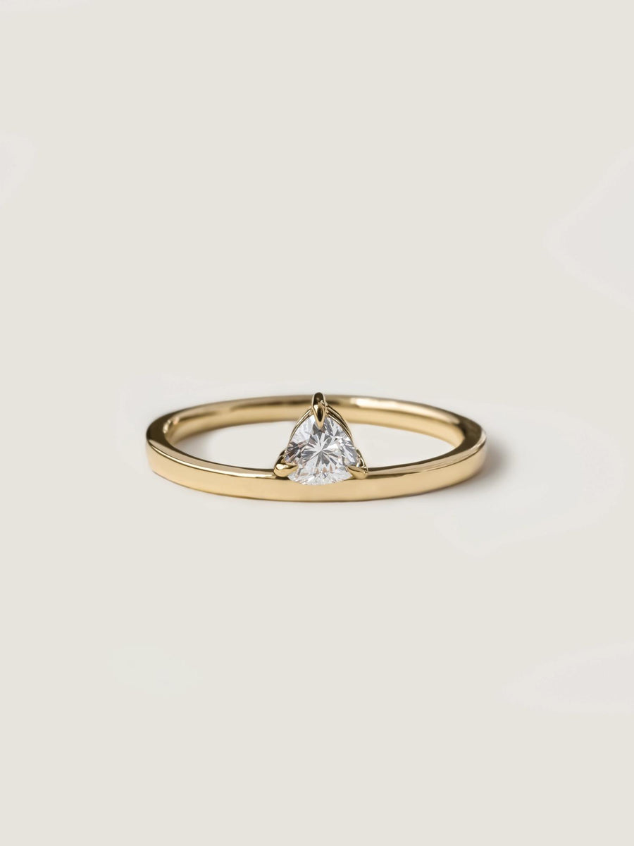 0.20 carat trillion cut lab grown diamond solitaire engagement ring in classic prong setting on polished gold band