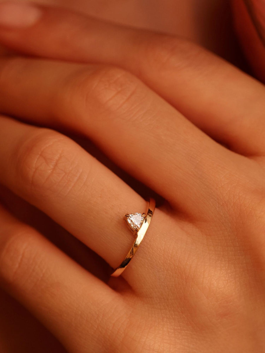 0.20 carat trillion cut lab grown diamond solitaire engagement ring in classic prong setting on polished gold band