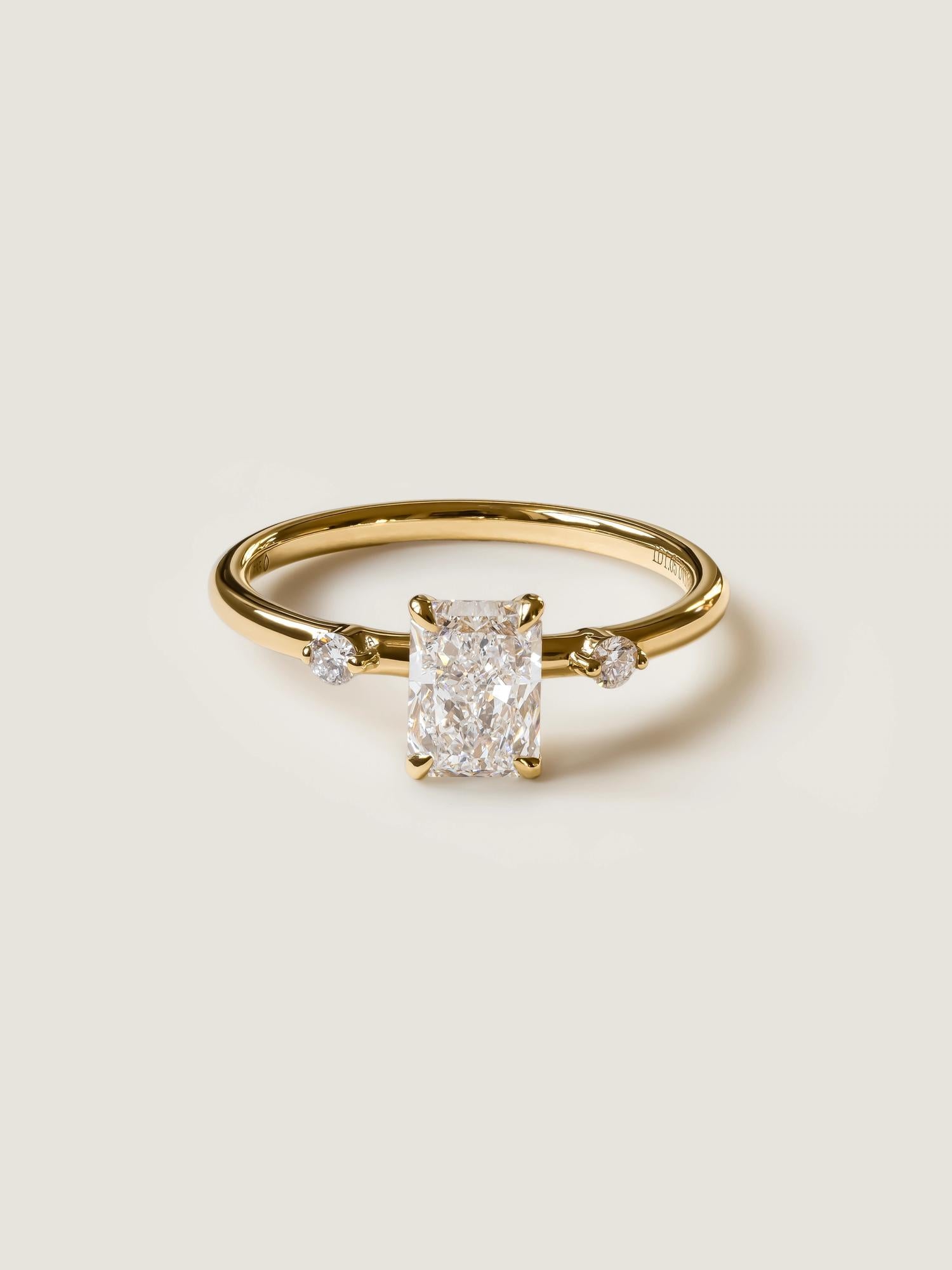 Radiant cut lab grown diamond three stone engagement ring, 1.05 to 3.05 carats, set in polished gold band with prong setting