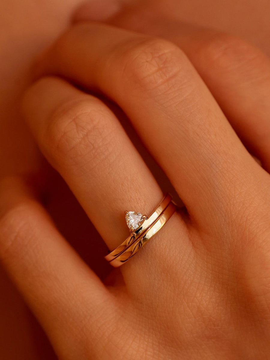 0.20 carat trillion cut lab grown diamond solitaire engagement ring in classic prong setting on polished gold band