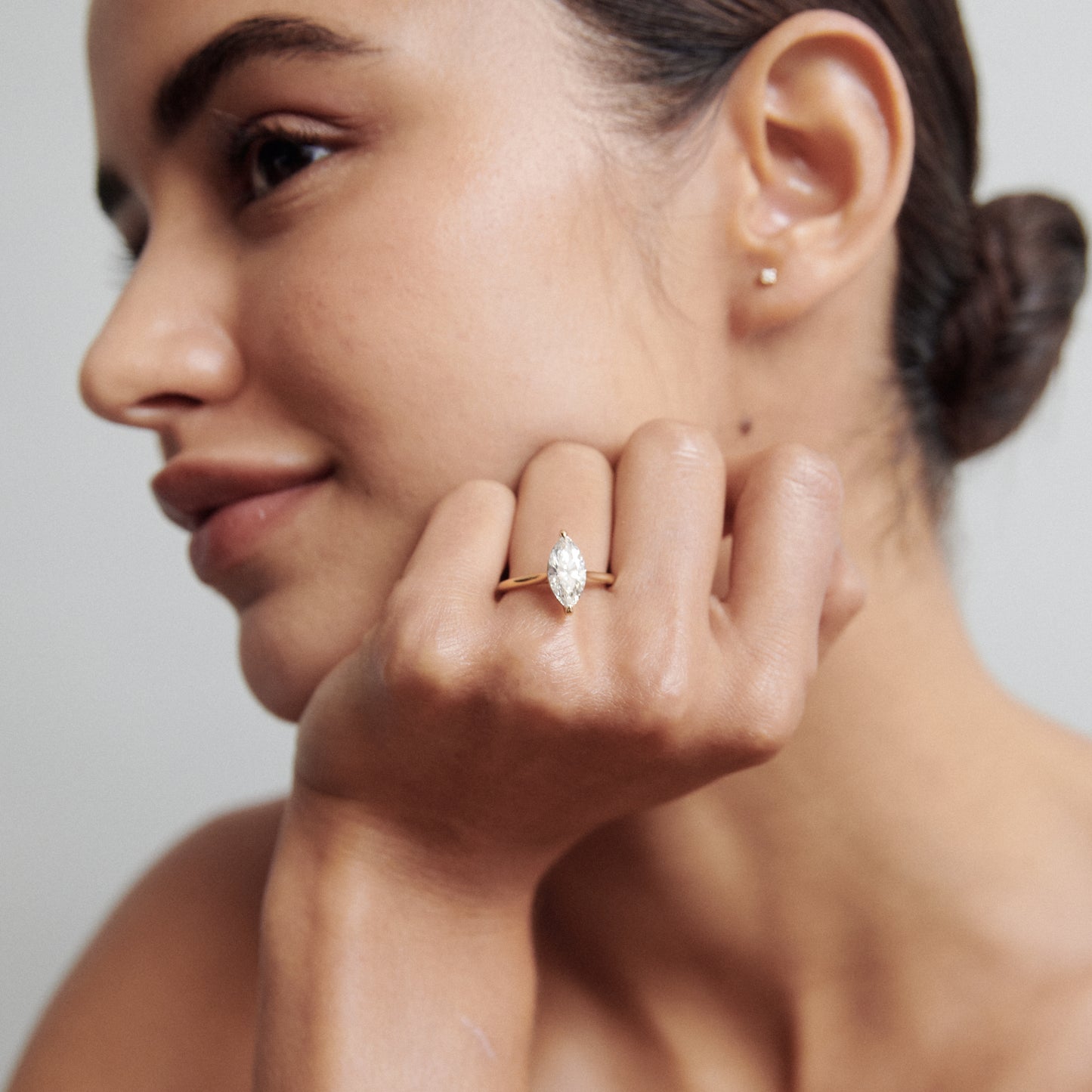 Marquise cut lab grown diamond solitaire engagement ring in classic prong setting on polished gold band