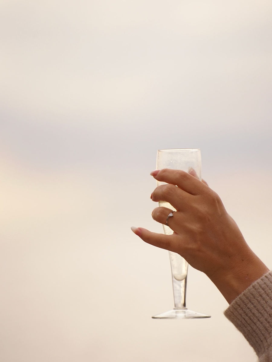 0.20 carat trillion cut lab grown diamond solitaire engagement ring in classic prong setting on polished gold band