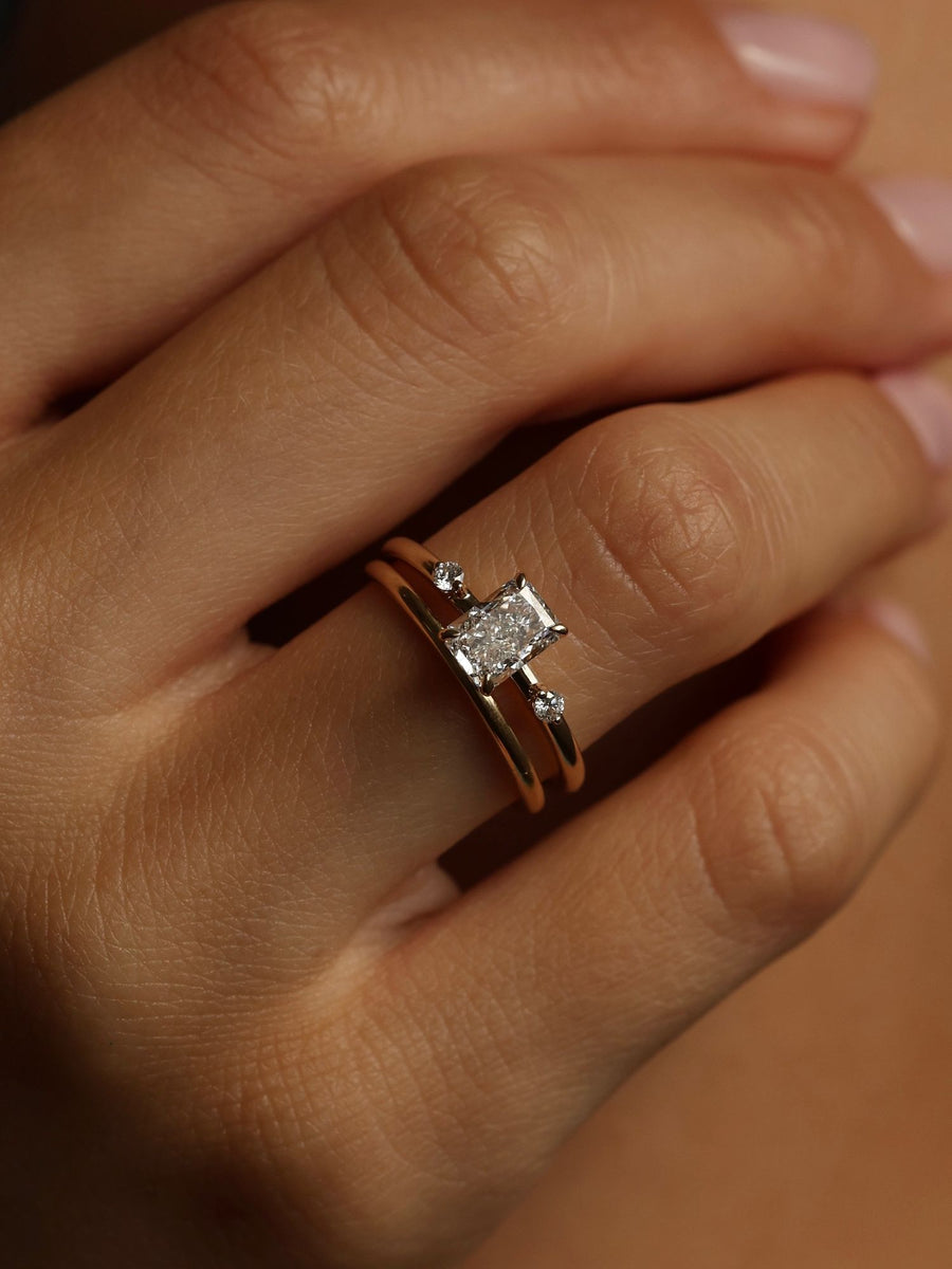 Radiant cut lab grown diamond three stone engagement ring, 1.05 to 3.05 carats, set in polished gold band with prong setting