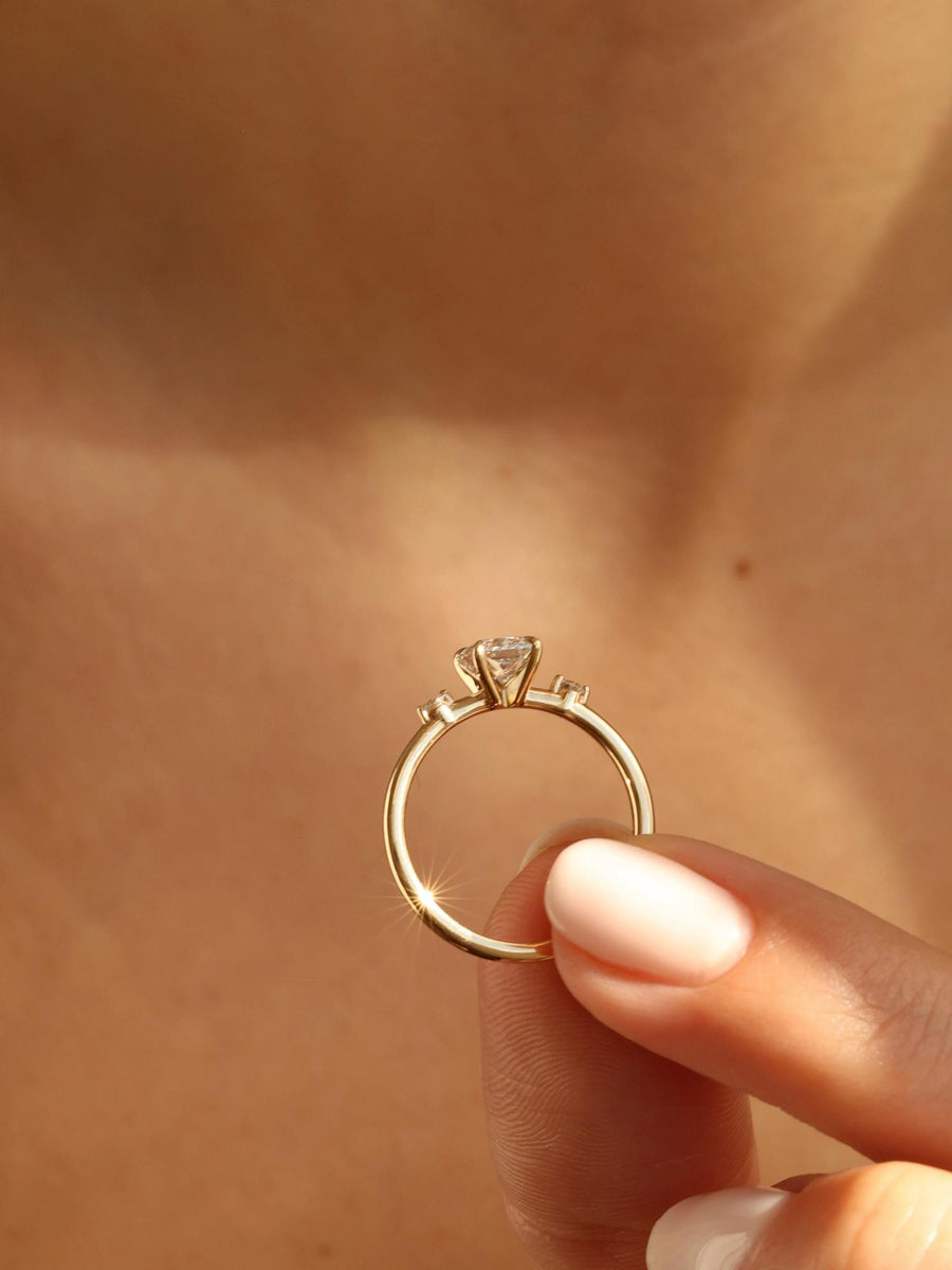 Radiant cut lab grown diamond three stone engagement ring, 1.05 to 3.05 carats, set in polished gold band with prong setting