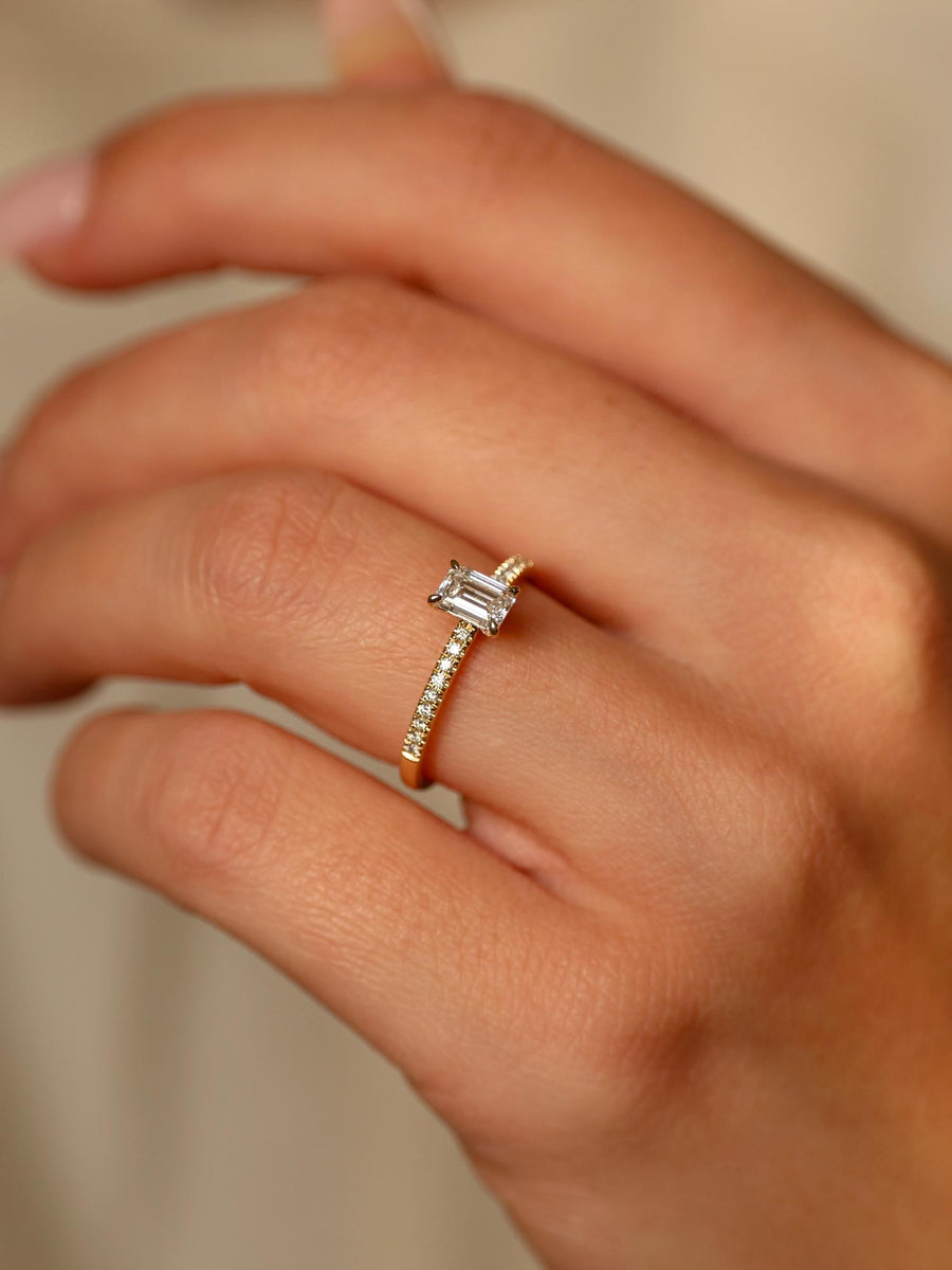 Emerald cut lab grown diamond pavé engagement ring, 0.50 to 2.50 carats, with side stones set in a polished gold band