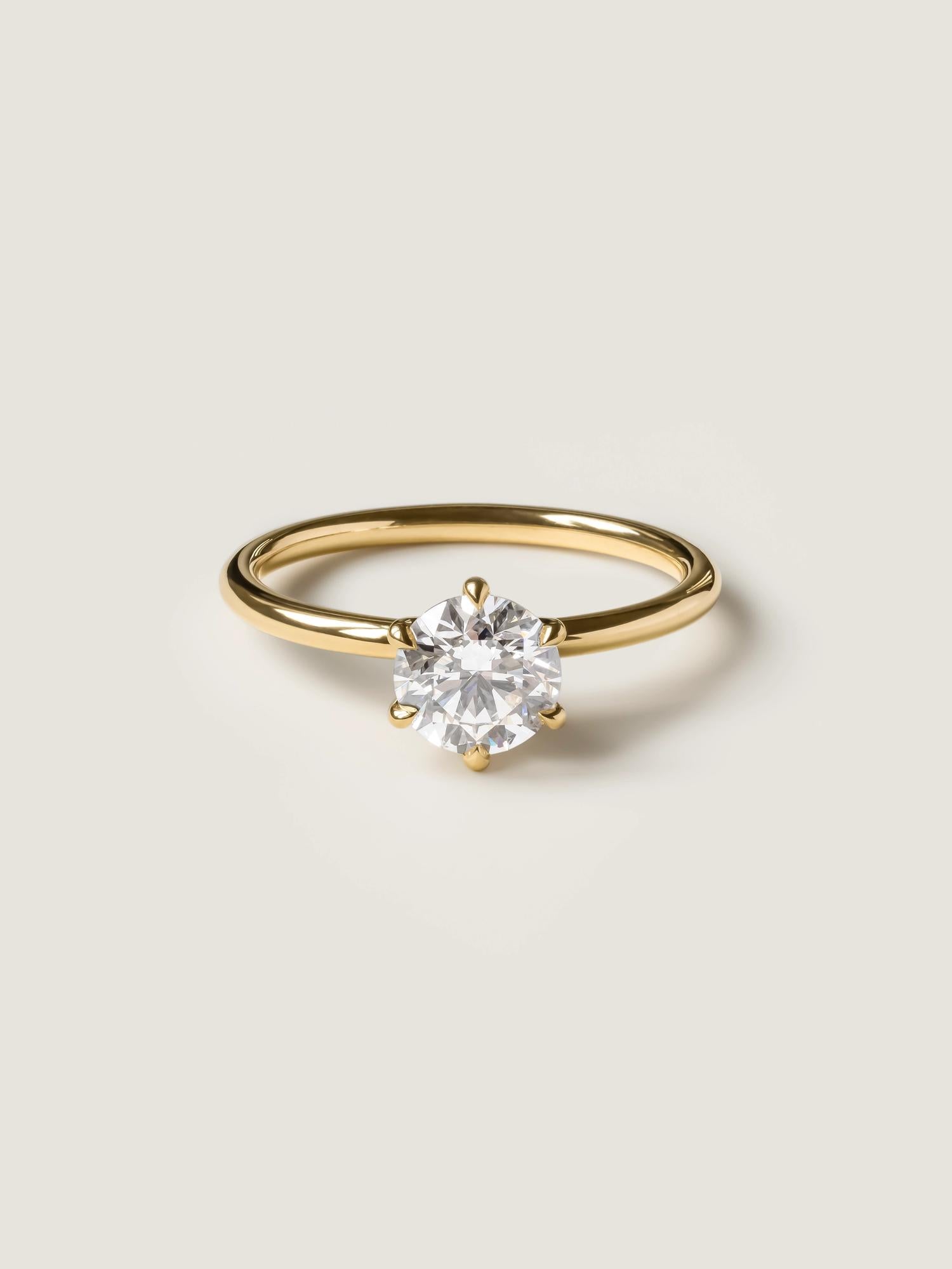 Round cut lab grown diamond solitaire engagement ring, 1.03 to 3.03 carats, set in a traditional prong setting on polished gold band
