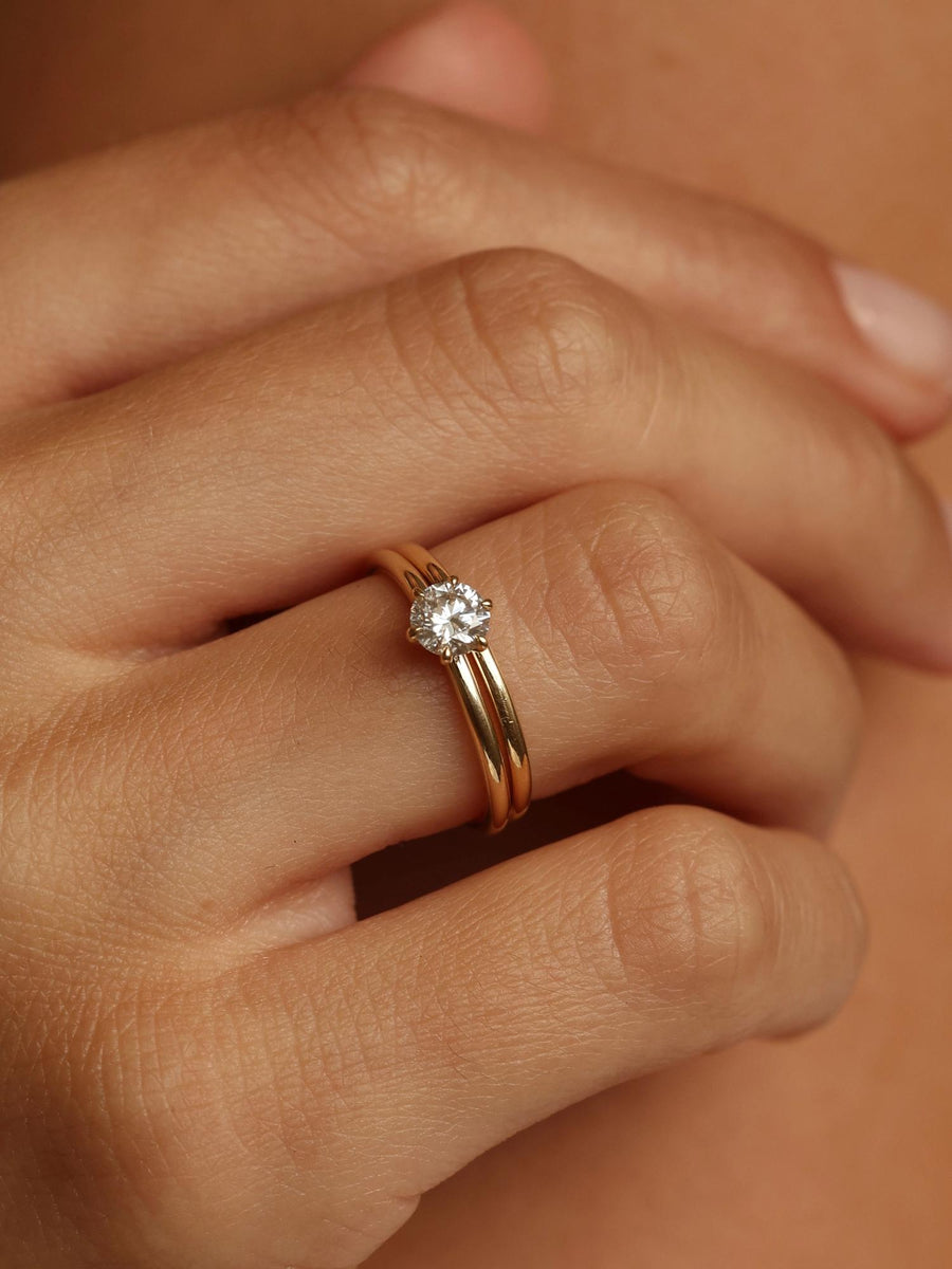 Round cut lab grown diamond solitaire engagement ring, 0.50 to 2.50 carats, set in a sleek prong design on polished gold band