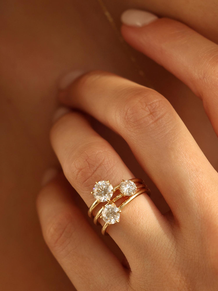 Round cut lab grown diamond solitaire engagement ring, 0.50 to 2.50 carats, set in a sleek prong design on polished gold band